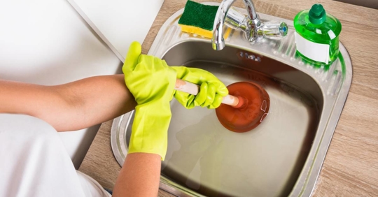 Woman using a plunger